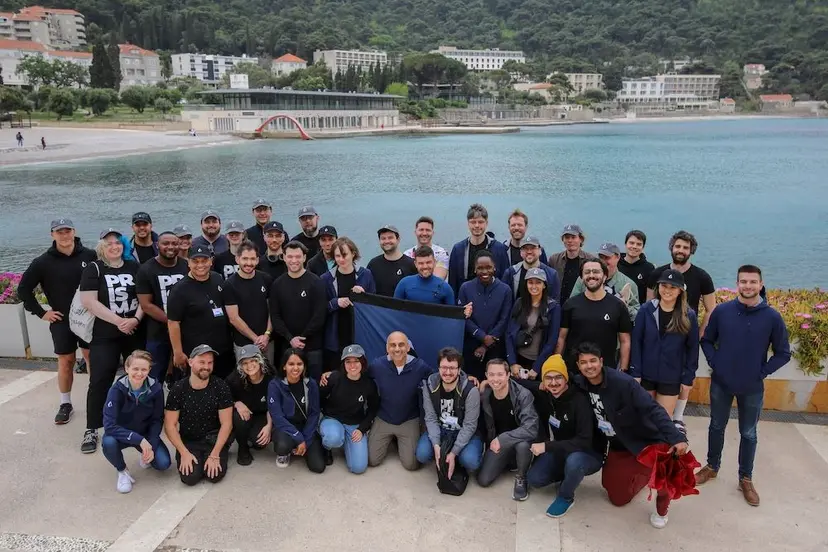Large Prisma team group photo with a mountain backdrop